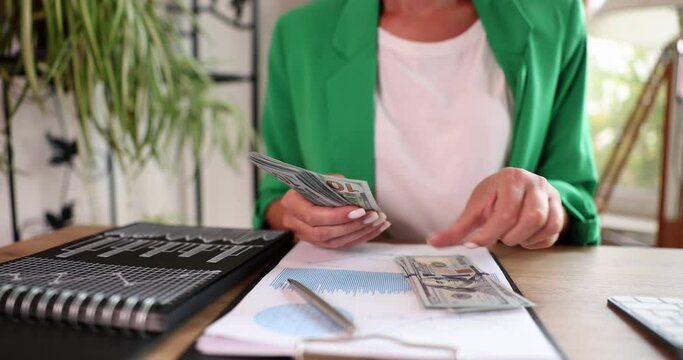 Businesswoman or accountant counting dollar bill at workplace. Female analyst auditor paperwork and cash flow investment and finance concept