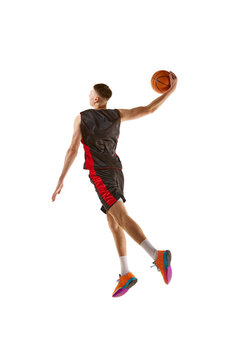 Full-length dynamic image of young man, basketball player practicing, playing isolated over white background. Concept of professional sport, competition, match, championship, health, action. Ad