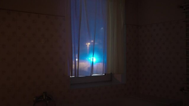 Out of focus police lights through the window