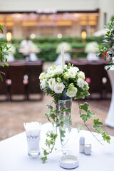 A vase of white  flowers wedding decoration on a table