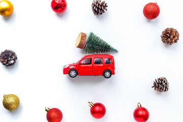 Red toy car with Christmas tree on the roof. Festive New Year concept