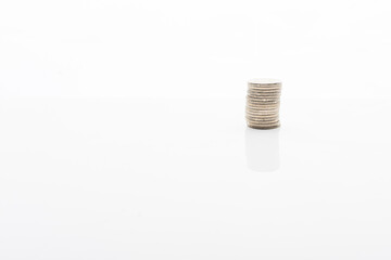 Coins stacked on white backgroud with smooth reflection. Concept of grow, investment, saving money.