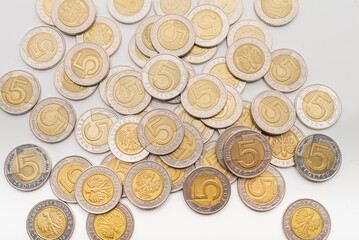 Polish Zloty coins. 1, 2 and 5 PLN coin background on the white table.