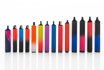 Disposable electronic cigarettes. Set of colorful e-cigarettes of different shapes. Concept of modern smoking.