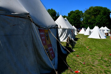 A close up on a set of tents decorated with crests of medieval families and noble houses spotted in...