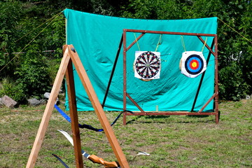 A close up on a set of archery practice targets located against a green protective cloth and with a...