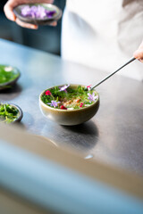 chef preparing the salad with stick