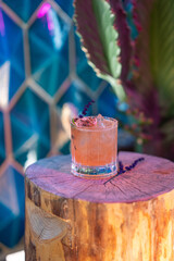 Colorful pumpkin fall-inspired cocktail with fall colors in background
