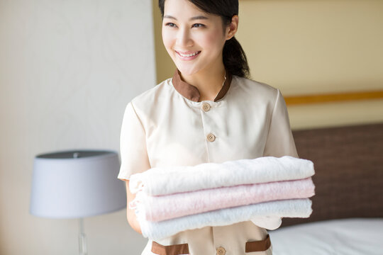 Domestic staff cleaning bedroom