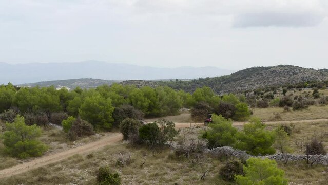 Off-Road Buggy Riders Through Dirt Roads In Brac Island, Croatia. Wide Shot