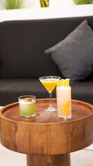 cocktails on podiums on colored background. Signature cocktails concept.