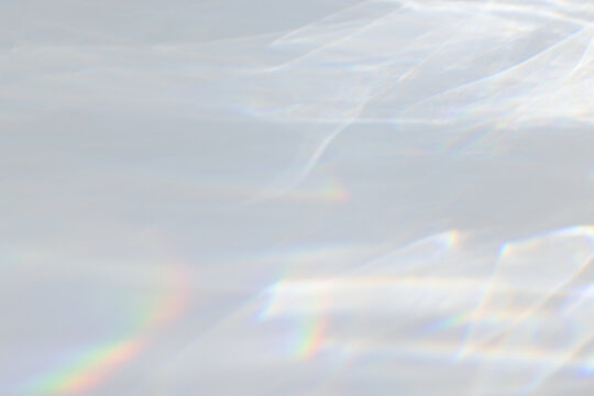  Crystal Prism Rainbow Light Refraction Texture On White Wall Background. Organic Drop Diagonal Holographic Flare On A White Wall. Water Shadows For Natural Light Overlay Effects