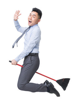 Young businessman flying on broom