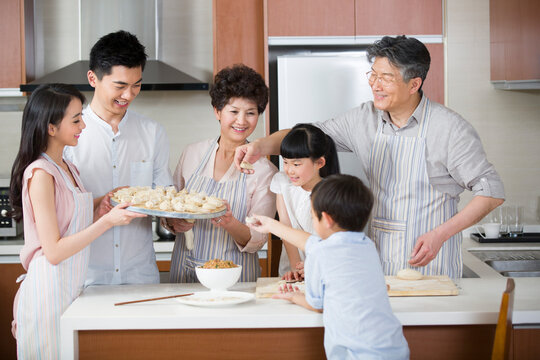 Happy family making dumplings