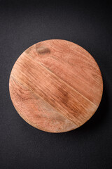Beautiful round wooden cake stand on a textured concrete background