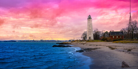 New Haven Landmark Lighthouse at the beachfront of Morgan Point Park, built in 1847 in Connecticut. Winter coastal landscape in New England at dramatic cloudy sunset in America. - obrazy, fototapety, plakaty