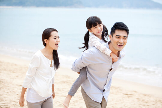 Happy young family enjoying the beautiful beach of Repulse Bay, Hong Kong