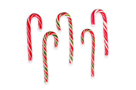 New Year's sticks candy canes with stripes on a white isolated background close-up