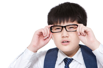 Nearsighted schoolboy having trouble seeing things clearly adjusting his glasses