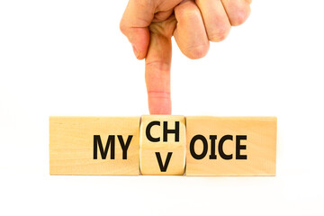 My voice choice symbol. Businessman turns wooden cubes and changes the concept word My choice to My voice. Beautiful white table white background, copy space. Business and my voice choice concept