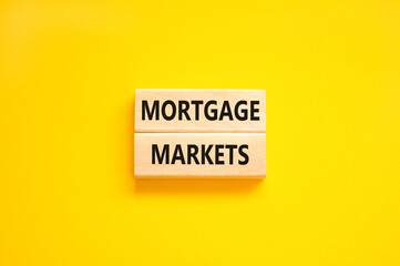 Mortgage markets symbol. Concept words Mortgage markets on beautiful wooden blocks. Beautiful yellow table yellow background. Business mortgage markets concept. Copy space.