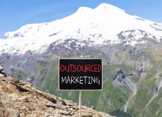 Outsourced marketing symbol. Concept words Outsourced marketing on beautiful black chalk...