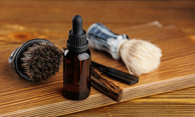 Bottle essential oil for beard men on background dark brick. Concept banner spa barbershop cosmetics for man.