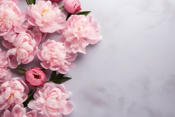 Fototapeta na wymiar a bouquet of pink peonies on a white marble background with a place for a text or an image.