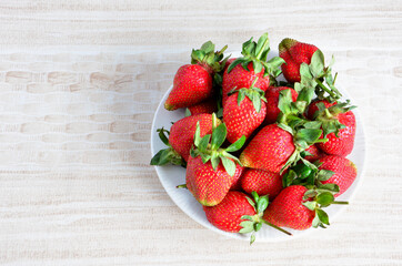 plate with red strawberries top view  