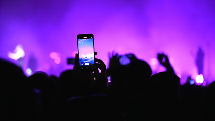 A lot of fun happy people record music video use mobile phone. Fan crowd shoot k pop live concert....