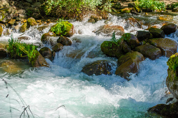 Immerse yourself in the tranquility of a mountain stream as the glistening water flows over...