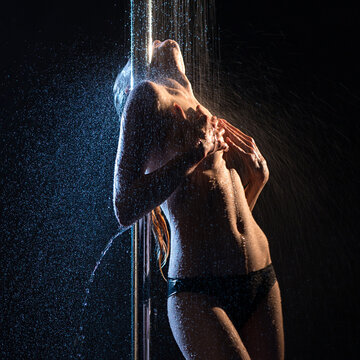 Girl topless having shower in the dark view
