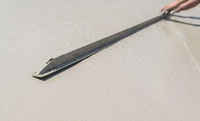 Hand worker plastering cement floor, Equipment metal handle manual hardware workplace construction site