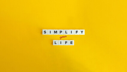 Simplify Your Life. Eliminating Clutter, Block Letter Tiles and Cursive Text on Yellow Background....
