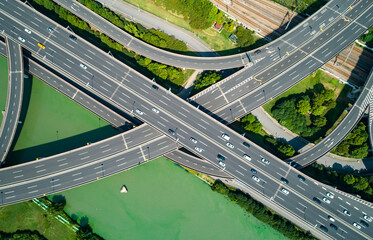 Aerial drone view of highway multi-level junction road with moving cars. China.