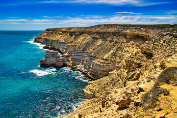 The wild coast with cliffs of layered sandstone of Kalbarri National Park, along the midwest coast of Western Australia - obrazy, fototapety, plakaty