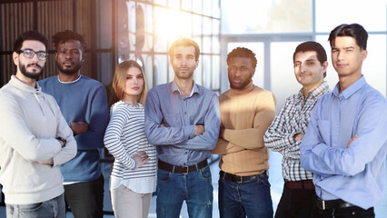 Fototapeta premium Positive multi racial corporate team posing looking at camera