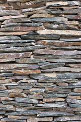 Stacked layered stone wall vertical view with lots of detail