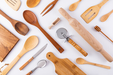 Kitchen wooden utensils, cooking tools on white background. Flat parallel diagonal layout. Kitchen...