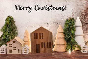 Merry Christmas Greeting Card with wooden small houses in Scandinavian style and Wooden Pine trees