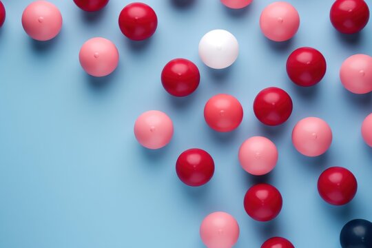  a group of red and white balls on a blue surface with a white ball in the middle of the image.