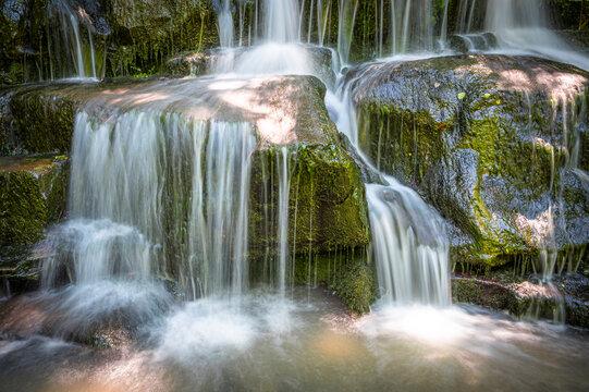 The waterfall flowing through mossy rocks and the water shot like a veil with a long exposure technique © Aytug Bayer