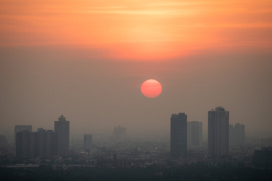 PM 2.5 dust in Bangkok, Thailand. Covered by heavy smog, Misty sunset in downtown with bad air pollution, Bad air pollution in City. Landscape with bad air pollution and Dangerous