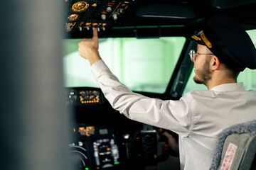 Airplane cabin The pilot checks the plane's electronics by pressing the buttons Preparing the...