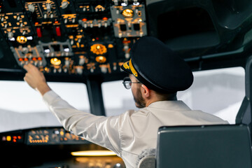 Airplane cabin The pilot checks the plane's electronics by pressing the buttons Preparing the...