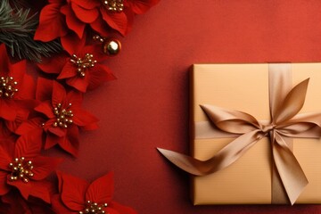  a gift wrapped in gold paper with a brown ribbon and a bow on a red background with poinsettis.