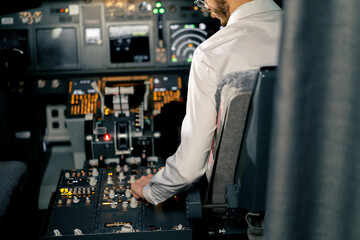 Airplane cabin The pilot checks the plane's electronics by pressing the buttons Preparing the...