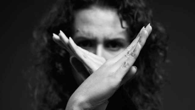 Upset Woman Making 'X' With Hands And Pointing Finger At Camera, Waving 'NO' In Rejection In Intense Monochromatic, Black And White