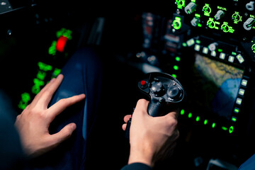 close-up of the cockpit of a military aircraft with a steering wheel and many buttons on the control panel of an airplane flight simulator