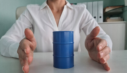 Blue barrels with oil on office table and business man insurance